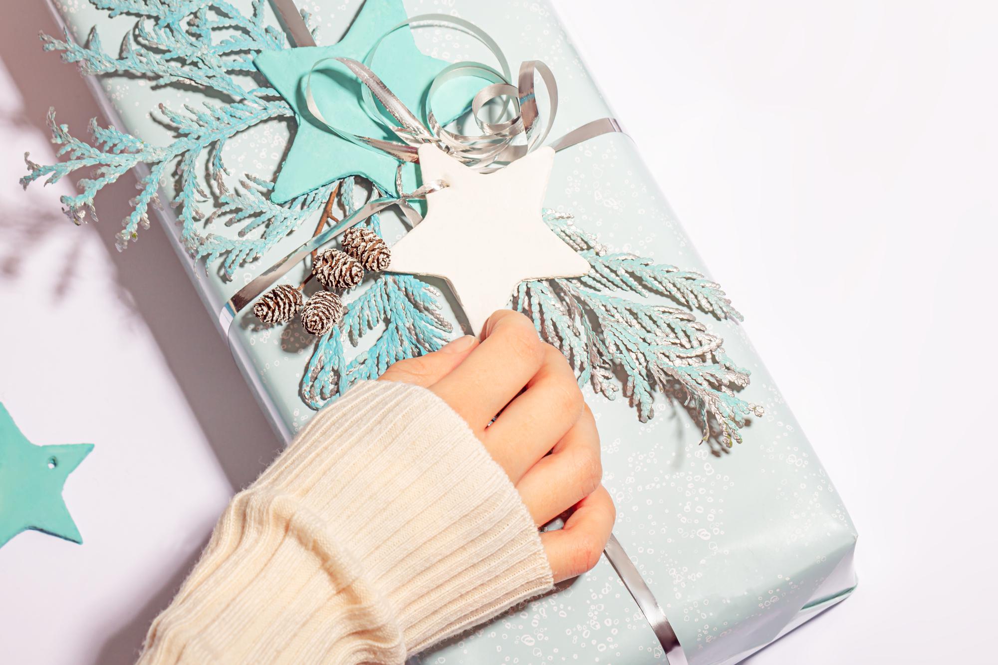 Hands preparing embroidered sample for shipping